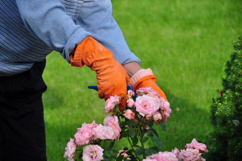 Gardener handing written free quote to homeowner in Beckenham